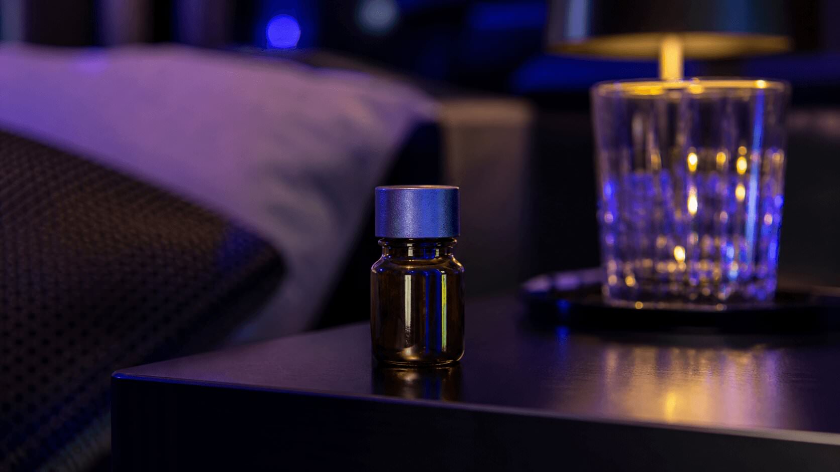 Poppers drug bottle on a dark bedside table with club lighting